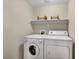 Laundry room with a washer and dryer and overhead storage shelf at 10550 W Alexander Rd # 2103, Las Vegas, NV 89129