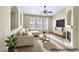 Bright, staged living room featuring a fireplace, ceiling fan, large windows and comfortable seating at 10550 W Alexander Rd # 2103, Las Vegas, NV 89129