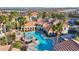 Aerial view of the community pool and hot tub, surrounded by lounge chairs and palm trees at 10550 W Alexander Rd # 2103, Las Vegas, NV 89129