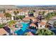 Aerial view of a resort-style pool area with palm trees and comfortable lounge seating at 10550 W Alexander Rd # 2103, Las Vegas, NV 89129
