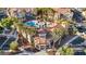 Aerial view of a beautiful community pool with palm trees and a spa at 10550 W Alexander Rd # 2103, Las Vegas, NV 89129