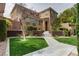 Inviting two-story home featuring a manicured lawn and a neutral color palette at 10616 Olympic Pine Dr, Las Vegas, NV 89135