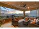 Relax on the outdoor balcony with comfy seating, string lights, and a picturesque mountain view at 12439 Iron Bluff Ave, Las Vegas, NV 89138