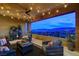 This outdoor balcony features beautiful views with comfortable seating and string lights at 12439 Iron Bluff Ave, Las Vegas, NV 89138