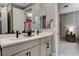 This bathroom features a double vanity with a large mirror, contemporary fixtures, and neutral decor at 12439 Iron Bluff Ave, Las Vegas, NV 89138