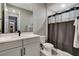 Bright bathroom featuring modern vanity with undermount sink and a shower with neutral-toned curtain at 12439 Iron Bluff Ave, Las Vegas, NV 89138