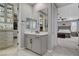 This bathroom features a vanity with gray cabinets, a large mirror, and access to the bedroom at 12439 Iron Bluff Ave, Las Vegas, NV 89138