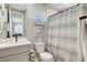 Cozy bathroom with white sink, toilet, and coastal-themed shower curtain at 12439 Iron Bluff Ave, Las Vegas, NV 89138