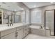 Elegant bathroom with double sink vanity, walk-in shower, and soaking tub at 12439 Iron Bluff Ave, Las Vegas, NV 89138