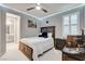 This bedroom features a dark wood bed frame and trim and a modern ceiling fan at 12439 Iron Bluff Ave, Las Vegas, NV 89138