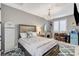 This bedroom features a stunning chandelier, neutral walls, and a decorative rug at 12439 Iron Bluff Ave, Las Vegas, NV 89138