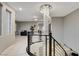 Bonus room with a chandelier, and projector screen viewed from the curved railing of the staircase at 12439 Iron Bluff Ave, Las Vegas, NV 89138