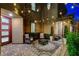 Cozy courtyard with stylish outdoor seating, a decorative rug, and ambient string lights at 12439 Iron Bluff Ave, Las Vegas, NV 89138