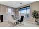 Elegant dining area with a glass table, modern chairs, and a view of the backyard at 12439 Iron Bluff Ave, Las Vegas, NV 89138