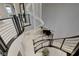 Grand foyer with a curved staircase and a modern chandelier, with views overlooking a piano on the floor below at 12439 Iron Bluff Ave, Las Vegas, NV 89138