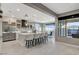 Bright kitchen features a central island with bar seating, stainless steel appliances, and modern pendant lighting at 12439 Iron Bluff Ave, Las Vegas, NV 89138