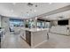 Bright, open-concept kitchen featuring a large island and modern finishes that flows into the living room area at 12439 Iron Bluff Ave, Las Vegas, NV 89138
