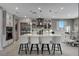 Well-lit kitchen with a large island, stainless steel appliances, and stylish bar stools at 12439 Iron Bluff Ave, Las Vegas, NV 89138
