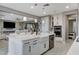 Spacious kitchen with a large island, white cabinetry, stainless steel appliances, and an open layout to the living room at 12439 Iron Bluff Ave, Las Vegas, NV 89138