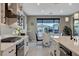 Modern kitchen with stainless steel appliances, quartz countertops, custom cabinets, and an adjacent dining area at 12439 Iron Bluff Ave, Las Vegas, NV 89138