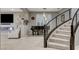 Open-concept living room featuring a fireplace, media center, tile floors, and a curved staircase at 12439 Iron Bluff Ave, Las Vegas, NV 89138