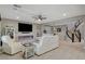 Bright living room with linear fireplace, plush seating, tile flooring, and open access to the staircase at 12439 Iron Bluff Ave, Las Vegas, NV 89138