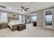 Spacious main bedroom with ceiling fan, seating area, and access to the balcony at 12439 Iron Bluff Ave, Las Vegas, NV 89138