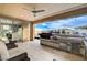 Luxurious covered outdoor kitchen featuring a built-in grill, sink, and seating area, perfect for entertaining at 12439 Iron Bluff Ave, Las Vegas, NV 89138