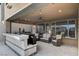 Charming covered outdoor kitchen with a built-in grill, ample counter space, and comfortable seating area at 12439 Iron Bluff Ave, Las Vegas, NV 89138