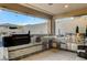 Outdoor kitchen featuring built-in stainless steel appliances and a tiled bar for entertaining at 12439 Iron Bluff Ave, Las Vegas, NV 89138