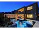 An elegant pool area features a spa and a waterfall, complemented by an outdoor bar at 12439 Iron Bluff Ave, Las Vegas, NV 89138