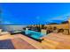 An elegant pool area features a sparkling pool and a spa alongside a waterfall feature at 12439 Iron Bluff Ave, Las Vegas, NV 89138
