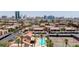 Aerial view of the community featuring a pool, tennis courts, carport parking, and nearby cityscape at 4421 Alexis Dr # 429, Las Vegas, NV 89103
