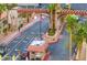 Community entrance with a guard house, palm trees and the US flag waving at 4421 Alexis Dr # 429, Las Vegas, NV 89103