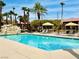 Community pool featuring clear blue water, comfortable seating, and a rock water feature at 4421 Alexis Dr # 429, Las Vegas, NV 89103