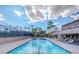 Community pool surrounded by lounge chairs and palm trees offering a great outdoor space at 4421 Alexis Dr # 429, Las Vegas, NV 89103