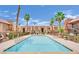 Community pool surrounded by palm trees at 4421 Alexis Dr # 429, Las Vegas, NV 89103