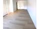 Bright room with light wood-look flooring and multiple white doors at 4421 Alexis Dr # 429, Las Vegas, NV 89103