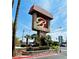 Stone signage featuring the community name, “Bella Vita,” against a sunny, blue sky in a landscaped entrance at 4421 Alexis Dr # 429, Las Vegas, NV 89103