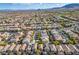 Expansive aerial view of a neighborhood with well-maintained homes and desert landscape in the distance at 10235 Headrick Dr, Las Vegas, NV 89166