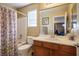 Bathroom featuring a shower-tub combo, vanity with sink, and neutral decor at 10235 Headrick Dr, Las Vegas, NV 89166