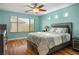 Inviting bedroom with wood-look flooring, a large window, and natural light at 10235 Headrick Dr, Las Vegas, NV 89166