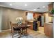 Charming dining area with a wooden table set, adjacent to the kitchen with stainless steel appliances at 10235 Headrick Dr, Las Vegas, NV 89166