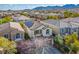 Beautiful two-story home with a tile roof, shutters, and desert landscaping at 10235 Headrick Dr, Las Vegas, NV 89166