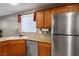 Functional kitchen area with stainless steel appliances, a sink, and dark wood cabinetry at 10235 Headrick Dr, Las Vegas, NV 89166