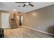 Open living area with wood-look flooring and staircase, providing an airy and inviting atmosphere at 10235 Headrick Dr, Las Vegas, NV 89166