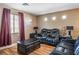 Cozy living room with plush seating, a window view, and laminate flooring at 10235 Headrick Dr, Las Vegas, NV 89166