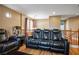 Upstairs living area with leather seating, wood floors, and natural light at 10235 Headrick Dr, Las Vegas, NV 89166