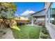 Backyard featuring a well-manicured lawn and covered patio with dining at 10332 Stroma Ave, Las Vegas, NV 89166