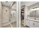 A modern bathroom includes double sinks and walk-in shower at 10332 Stroma Ave, Las Vegas, NV 89166